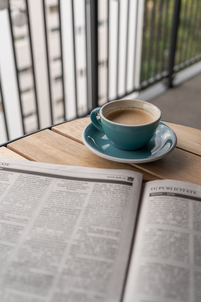 coffee-and-newspaper-on-a-balcony-table-34204819
